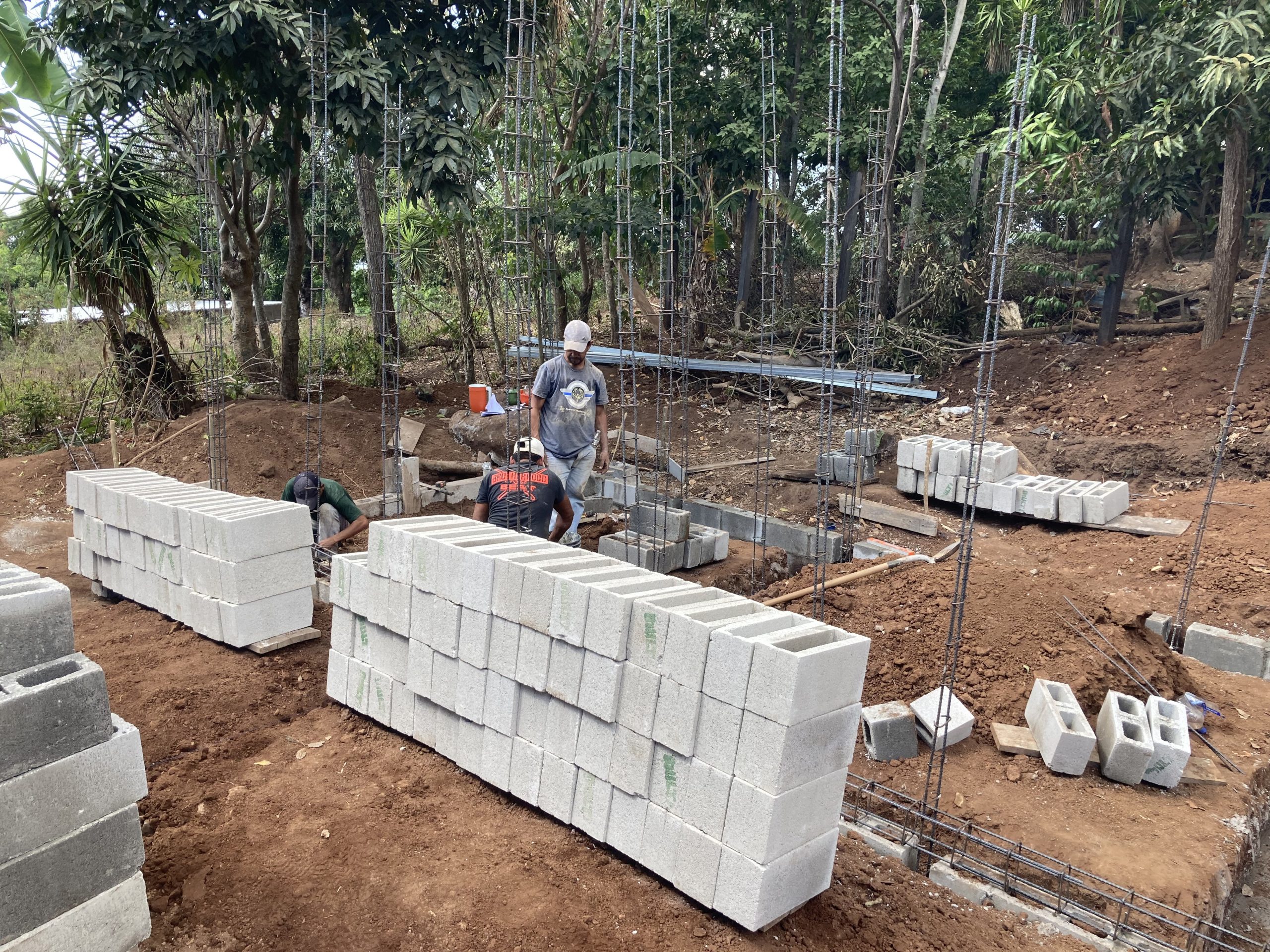 group of people sitting on ground with bonfire