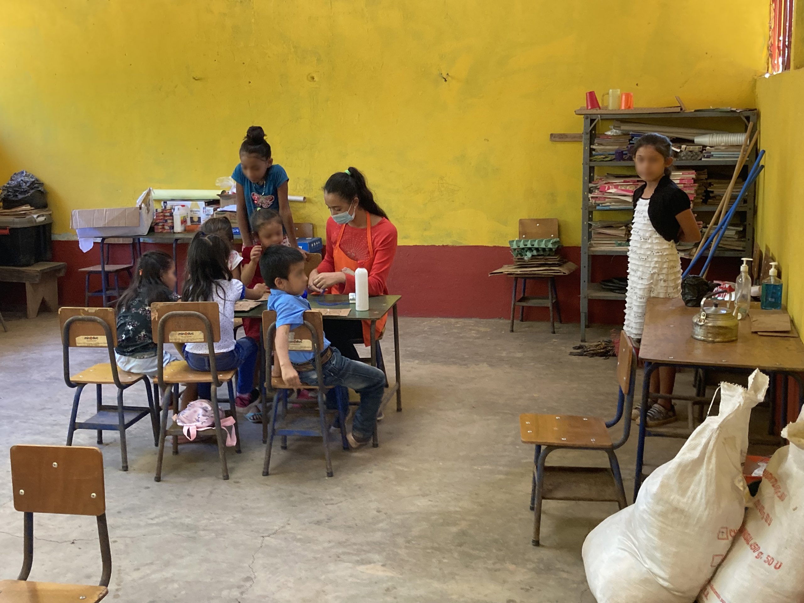 group of people sitting on ground with bonfire